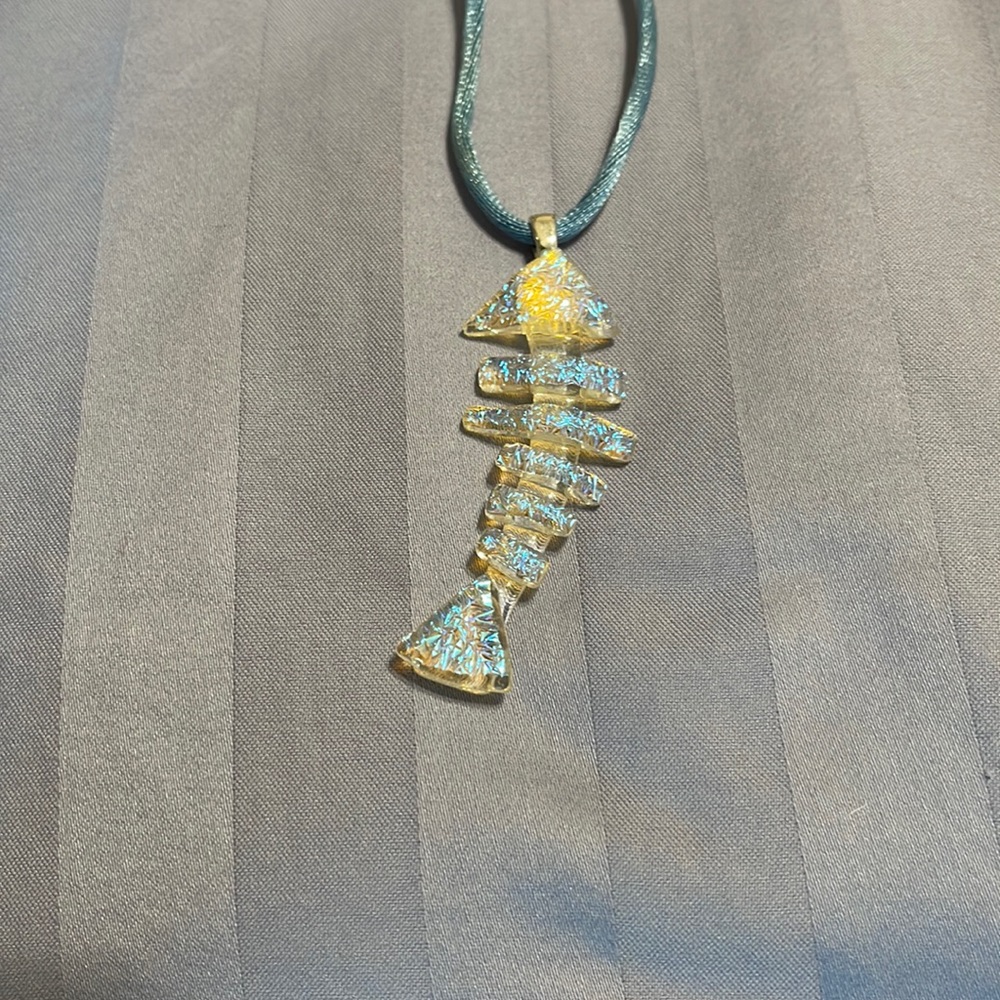 Iridescent fused glass fish on silk cord.